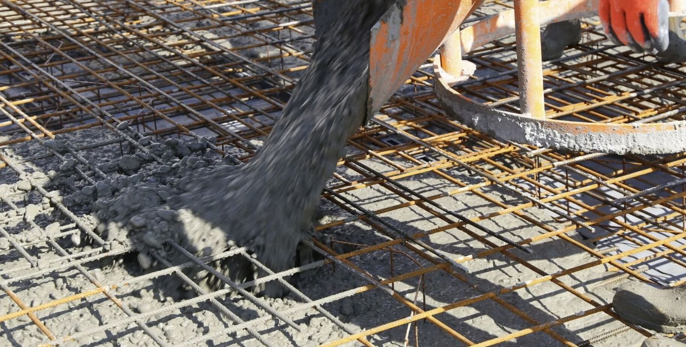 Concrete being poured over reinforced rebar grid for maximum strength