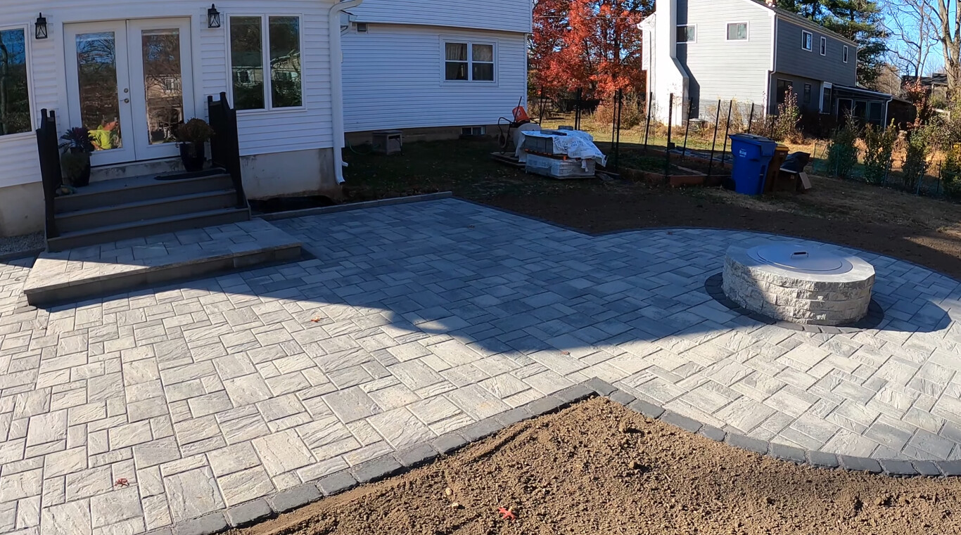 Beautiful stamped concrete patio with integrated fire pit feature